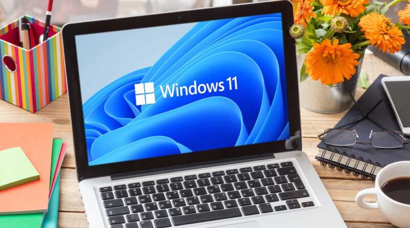 Windows 11 official brand sign on computer laptop display, business office table