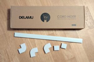 Delamu Cord Hider box with a few pieces scattered outside the box