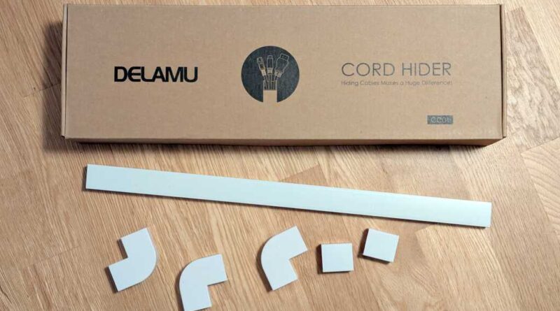 Delamu Cord Hider box with a few pieces scattered outside the box