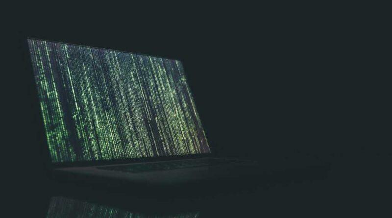 Fake code glitch on a laptop in a dark room