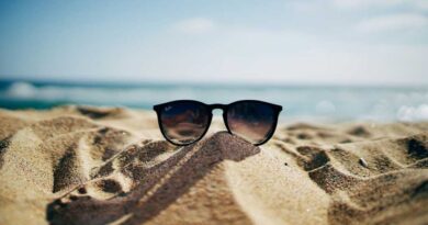 Sunglasses on top of a sand on a beach