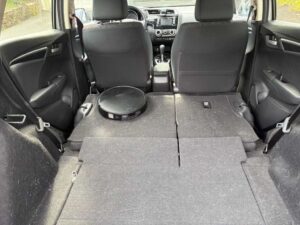A robot vacuum "cleaning" the back of a car