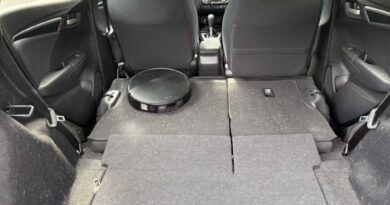A robot vacuum "cleaning" the back of a car