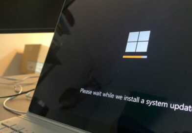 Windows 11 system update message on a laptop screen