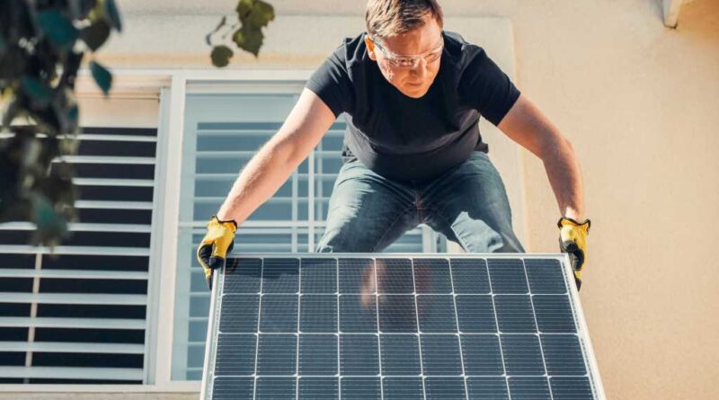 Man installing solar panel