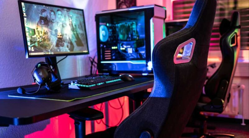 Gaming chair at a desk with gaming desktop PC rig and lots of RGB colors