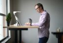 Man working from home with laptop on a standing desk