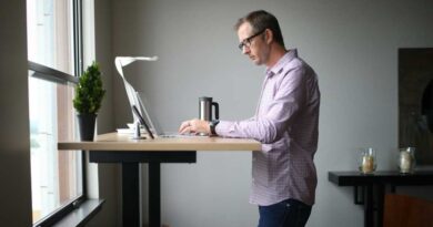 Man working from home with laptop on a standing desk